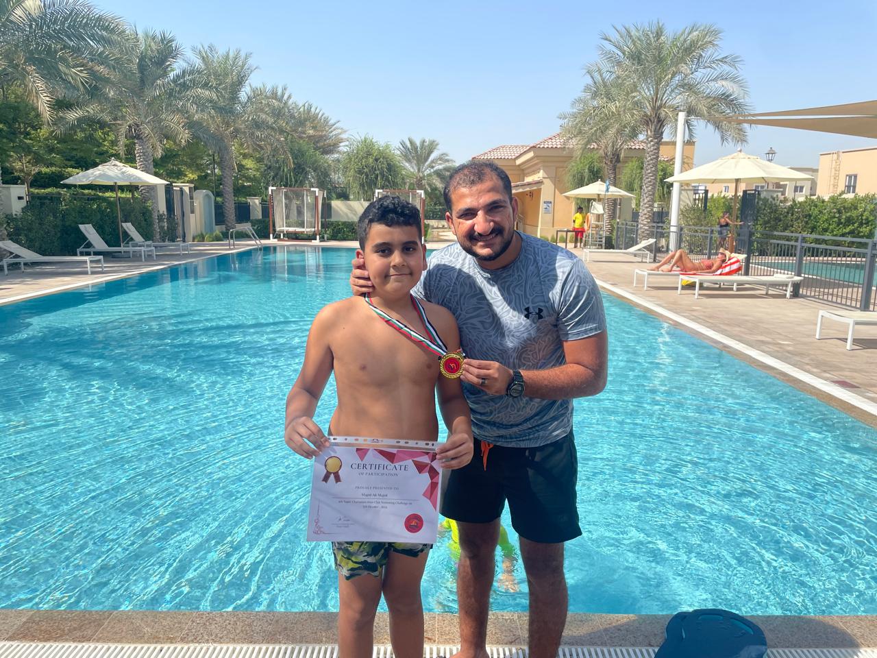 Swimming instructor helping child in pool